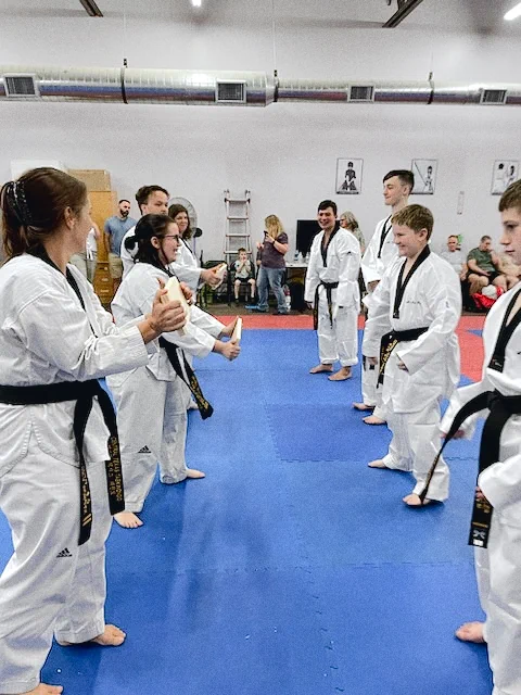 Adult Taekwondo students in white gis