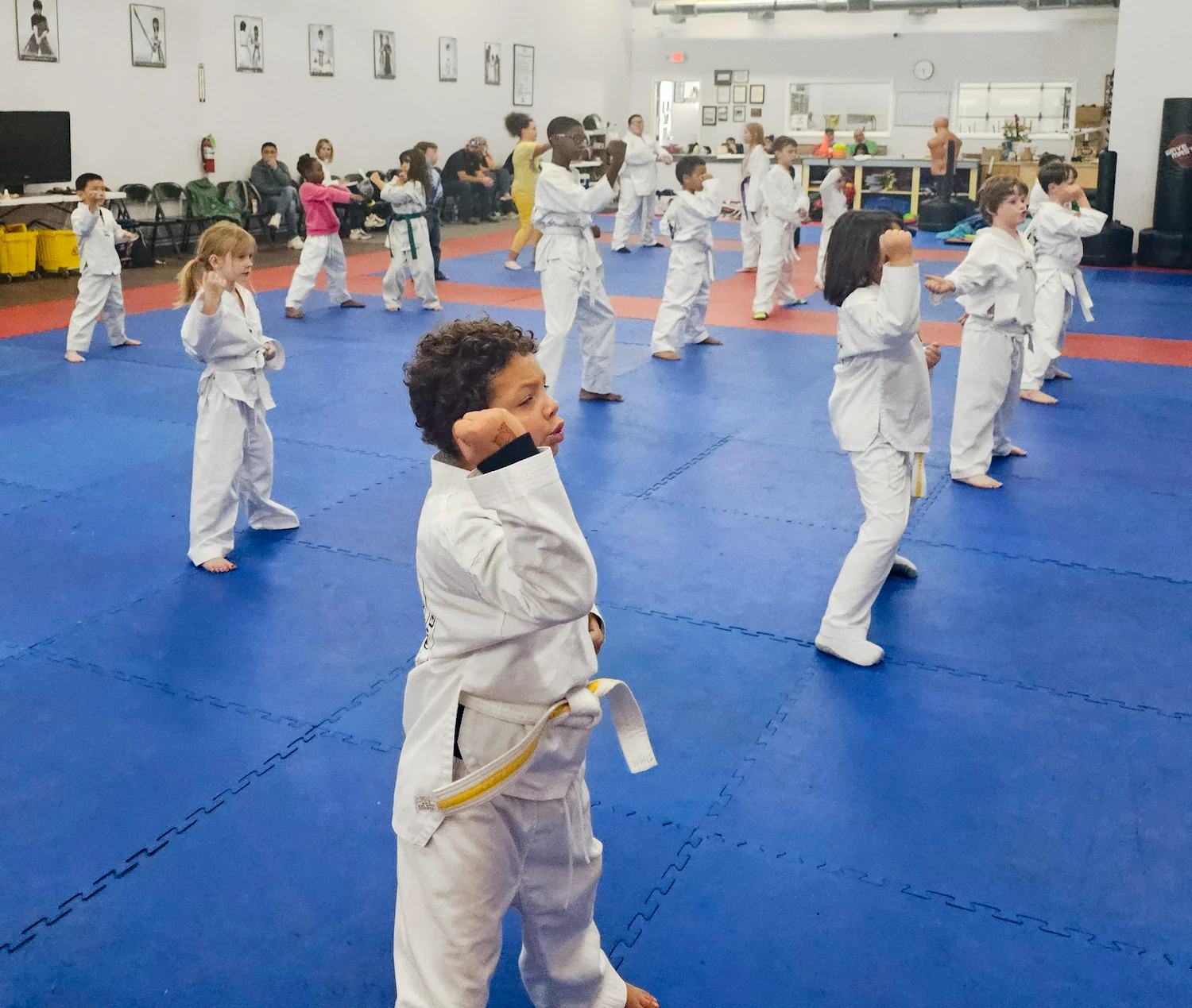 Children practicing Taekwondo forms during class