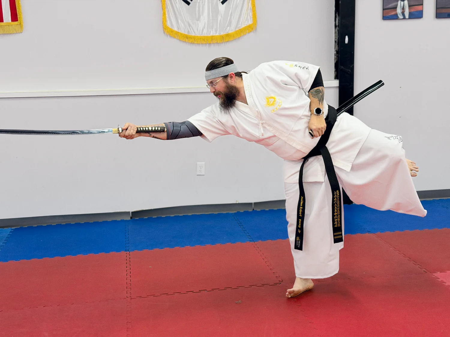 Instructor demonstraitin katana technique on one foot