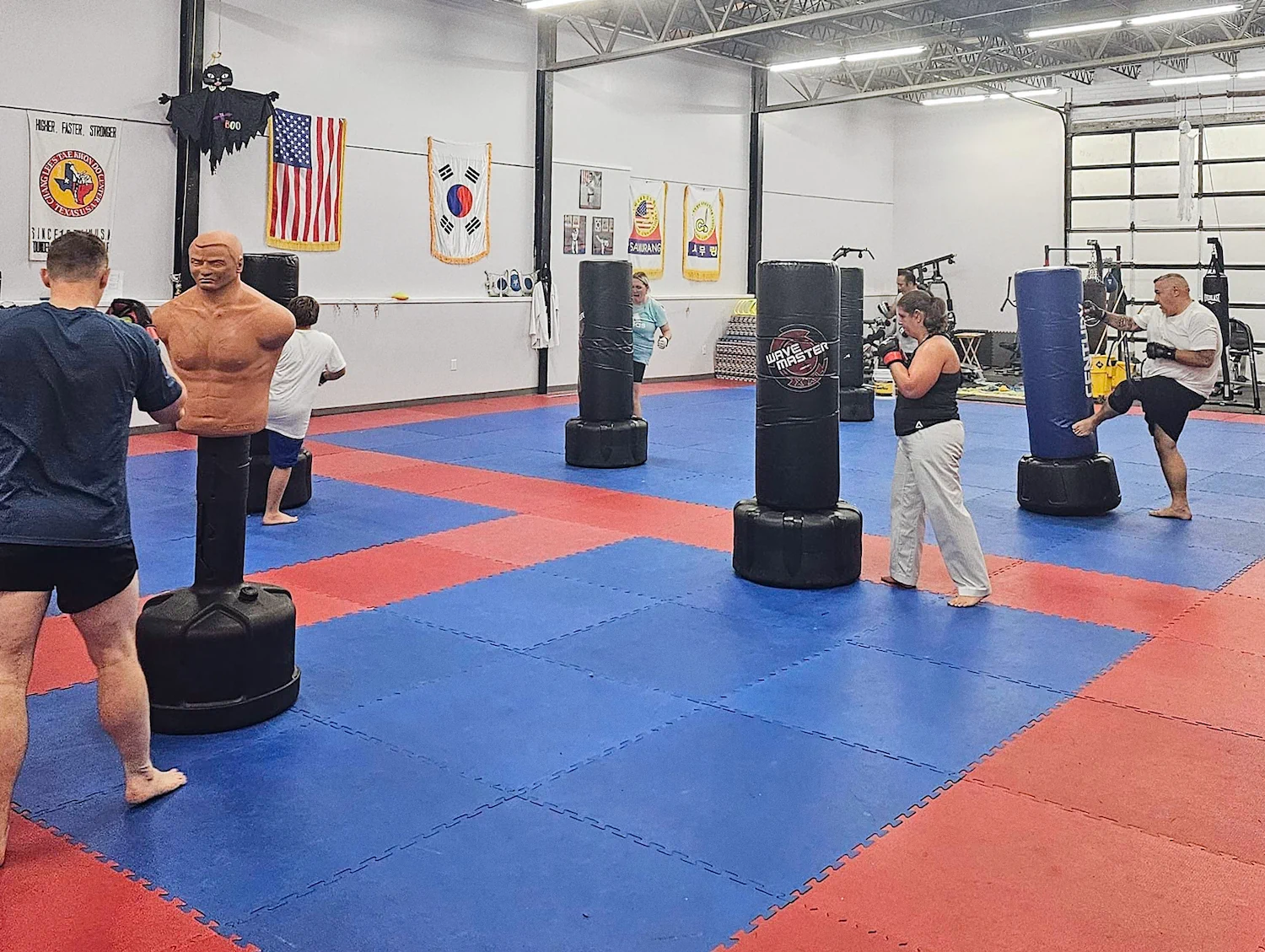 Young student with instructor holding Taekwondo belt test achievement