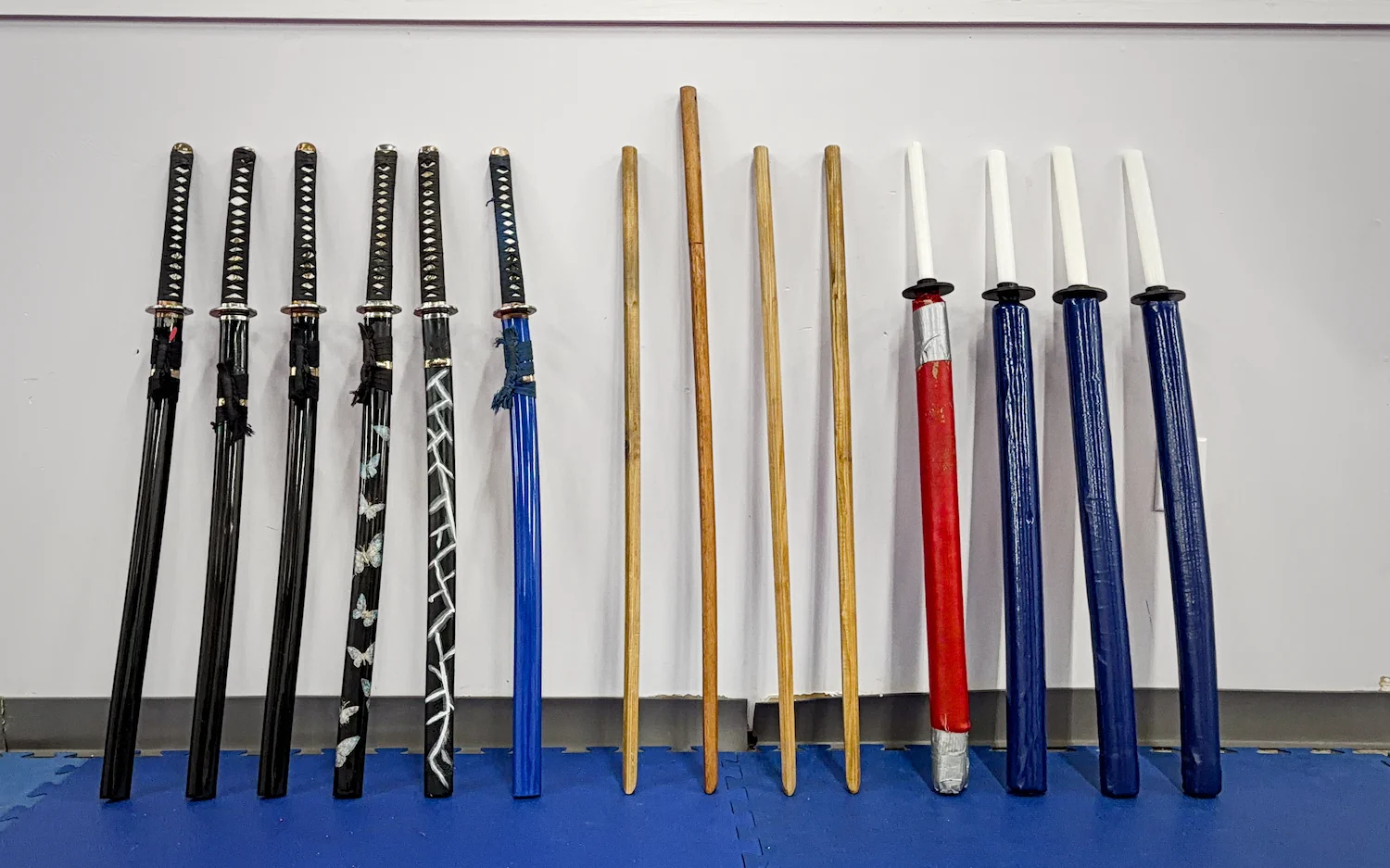 Collection of katanas and bo staffs